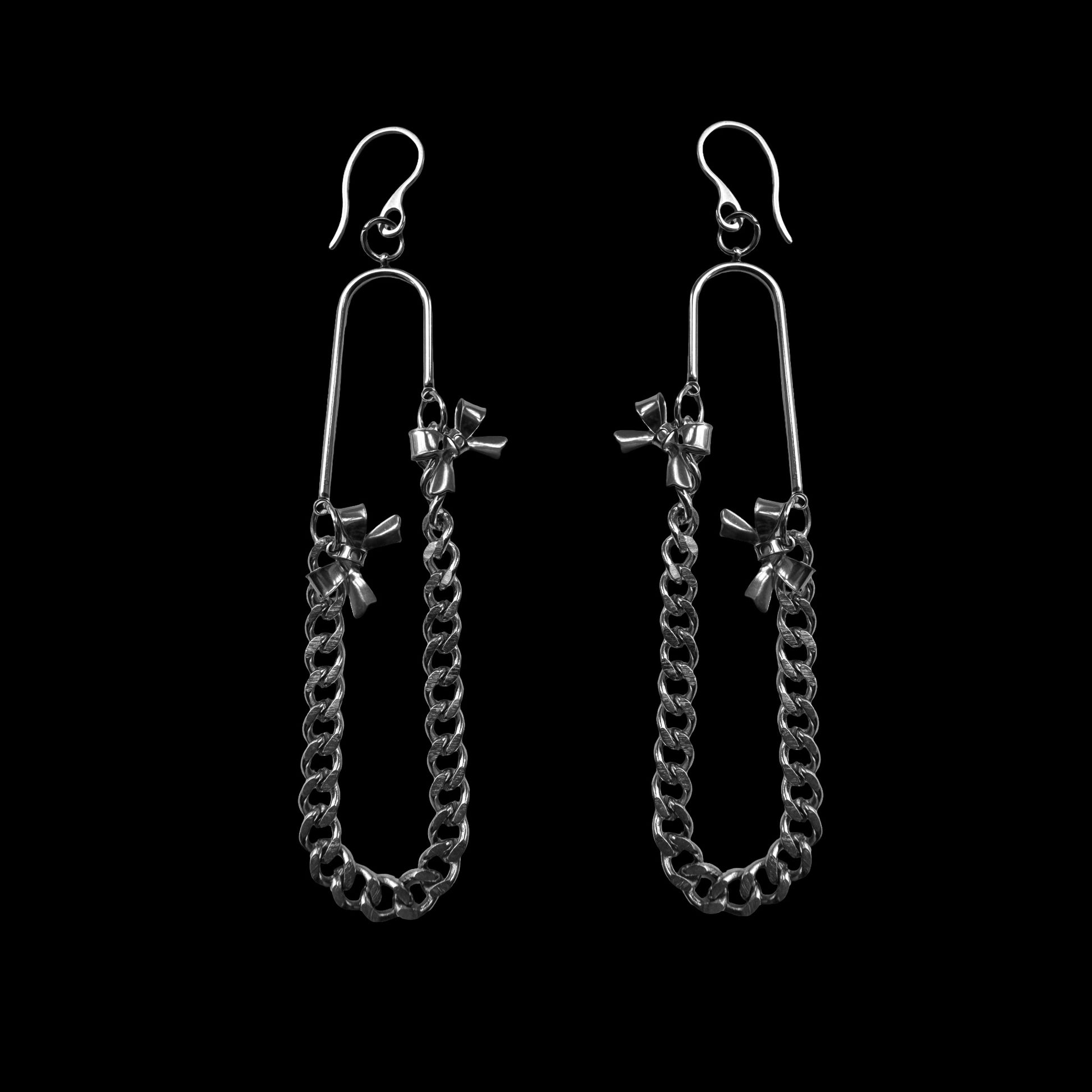 Pair of silver chain earrings on a black background