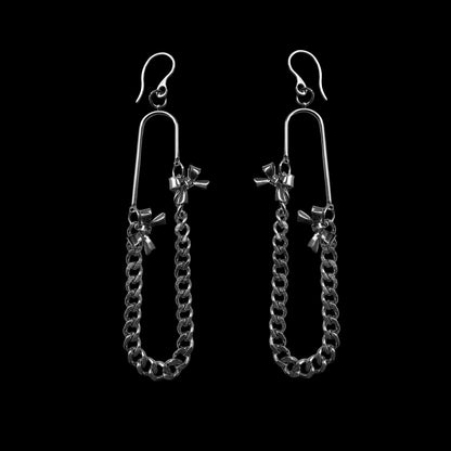 Pair of silver chain earrings on a black background